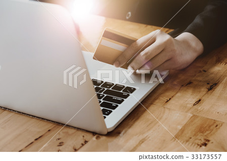 Close up hand of woman holding credit card Close up hand of woman holding credit card 33173557