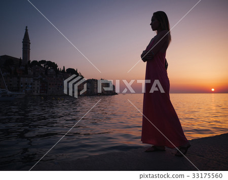 Woman enjoying a sunset in a Rovinj, Croatia 33175560