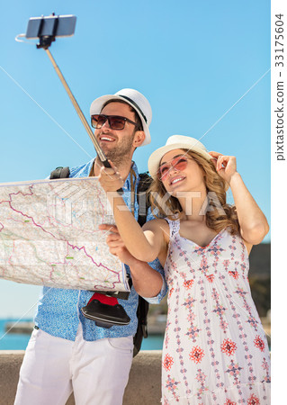 Couple of tourists photographing a selfie in a 33175604