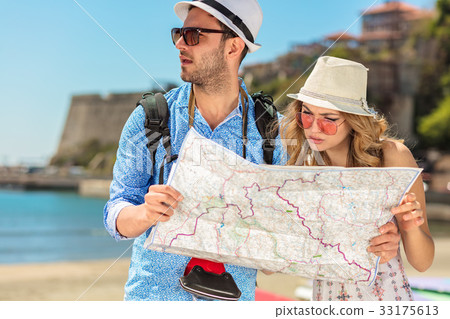 Couple tourist traveling and using map. Couple 33175613