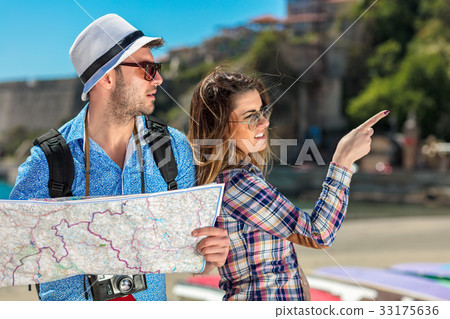 Couple tourist traveling and using map. Couple 33175636