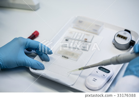 Close up of lab technician preparing blood test 33176388