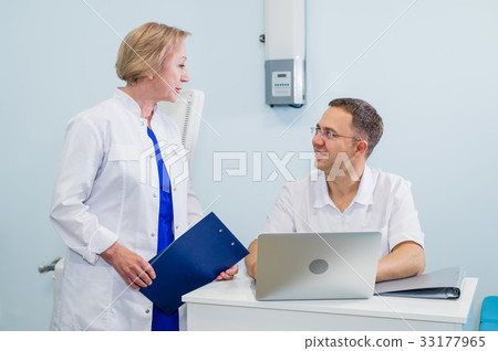 Doctor having conversation with his colleague and Doctor having conversation with his colleague and 33177965