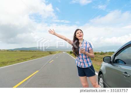 pretty woman with hand up calling passing car pretty woman with hand up calling passing car 33183757