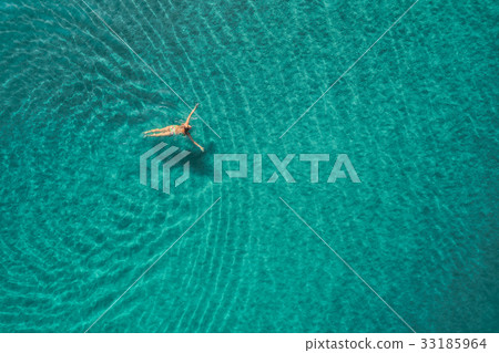 Aerial view of swimming woman in mediterranean sea Aerial view of swimming woman in mediterranean sea 33185964
