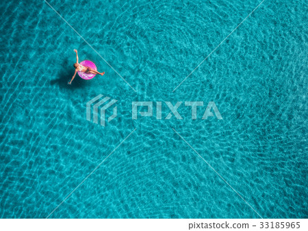 Aerial view of young woman swimming on the sea Aerial view of young woman swimming on the sea 33185965