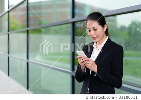 elegant office worker girl using mobile cell phone elegant office worker girl using mobile cell phone 33186511