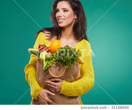 woman holding a bag full of healthy food. shopping . 33186690