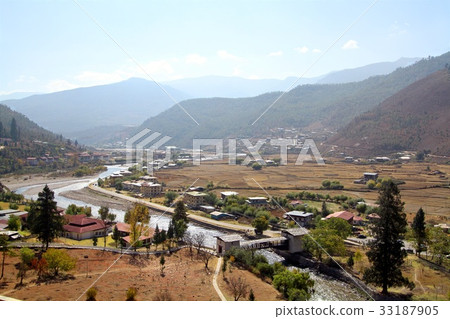 Bridge across the river with Bhutanese style house 33187905