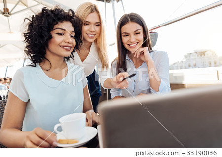 Nice cheerful women looking at the laptop screen 33190036