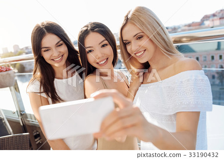 Delighted happy woman taking photos Delighted happy woman taking photos 33190432