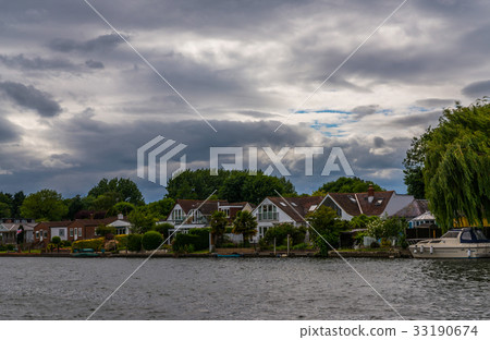 Wide river and houses on the shore, moored boats Wide river and houses on the shore, moored boats 33190674