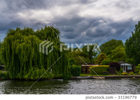 Wide river and houses on the shore, moored boats 33190779