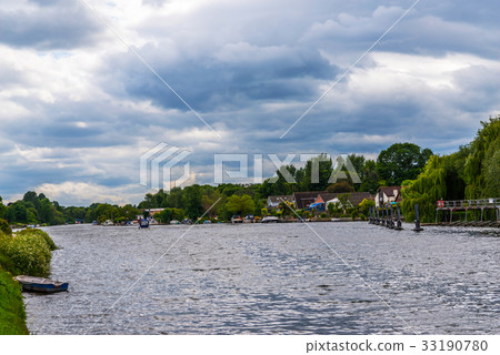 Wide river and houses on the shore, moored boats Wide river and houses on the shore, moored boats 33190780
