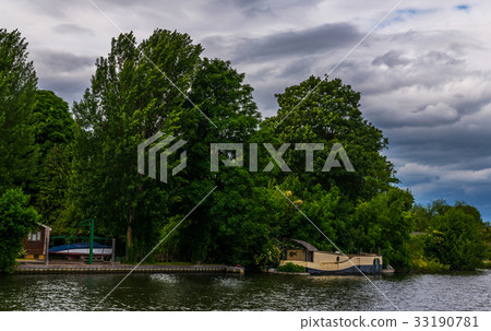 Wide river and houses on the shore, moored boats Wide river and houses on the shore, moored boats 33190781