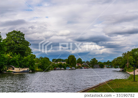 Wide river and houses on the shore, moored boats Wide river and houses on the shore, moored boats 33190782