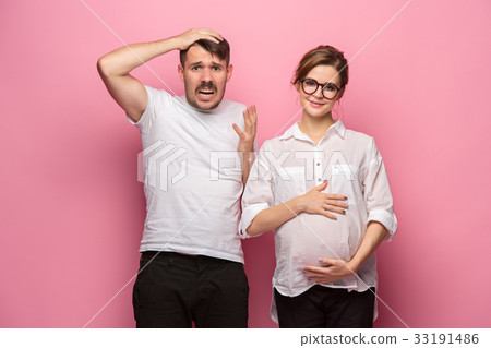 The funny surprised handsome man and his beautiful 33191486