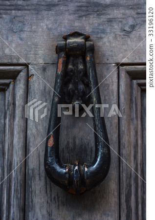 Door with brass knocker in the shape of a hand Door with brass knocker in the shape of a hand 33196120