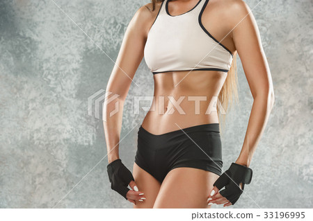 Muscular young woman athlete posing at studio Muscular young woman athlete posing at studio 33196995