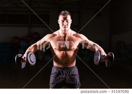 Muscular bodybuilder guy doing exercises with Muscular bodybuilder guy doing exercises with 33197090