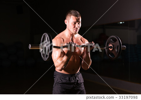Muscular man working out in gym doing exercises Muscular man working out in gym doing exercises 33197098