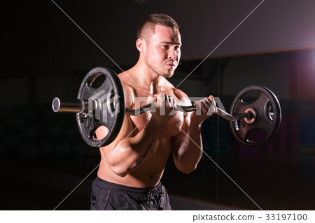 young man doing heavy weight exercise for biceps. 33197100