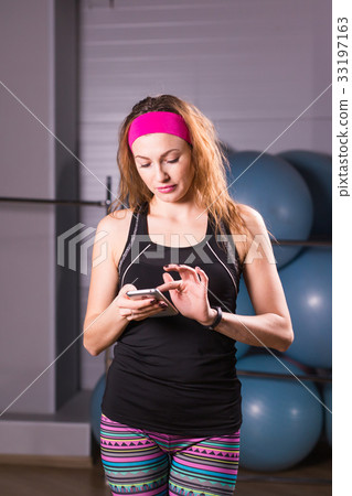 Young woman with fitness tracker in gym 33197163