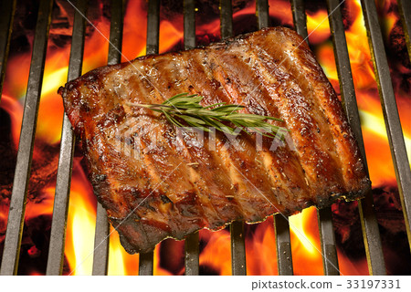 Grilled pork ribs on the flaming grill Grilled pork ribs on the flaming grill 33197331