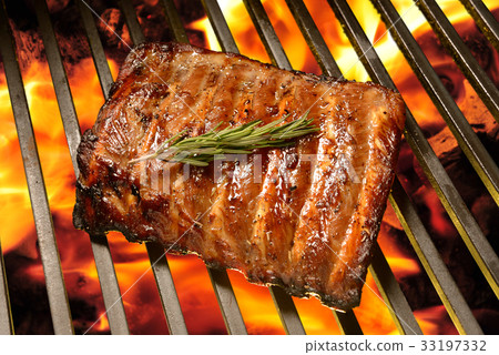 Grilled pork ribs on the flaming grill Grilled pork ribs on the flaming grill 33197332