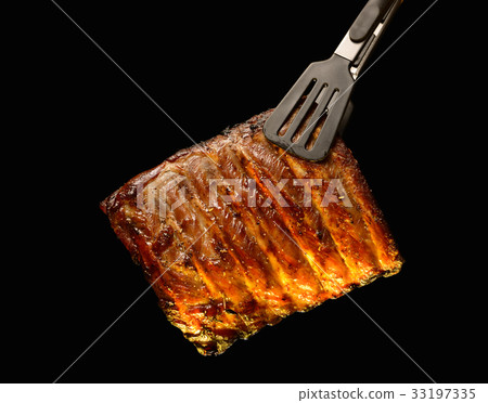 Grilled pork ribs isolated on black background Grilled pork ribs isolated on black background 33197335