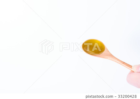 Olive oil on a wooden spoon 33200428