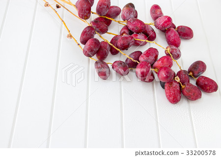 Bunch raw organic dates branch on white background 33200578