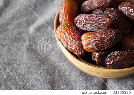 Fresh dates Medjool in wooden bowl  right corner 33200580