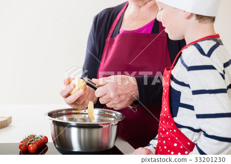 Grandma and grandson cooking together 33201230