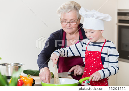 Grandma and grandson cooking together 33201231