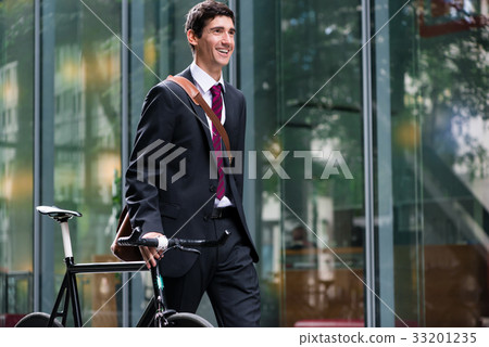 Happy active young man walking to the job after 33201235