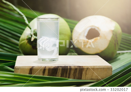 coconut juice and drinking coconut water in glass coconut juice and drinking coconut water in glass 33202017