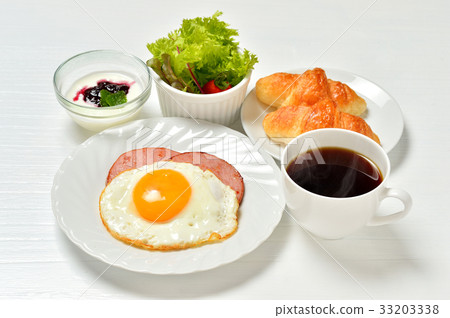 Breakfast croissants and coffee, fried eggs, ham saute, mini salad, yogurt. *Steam is synthetic. 33203338