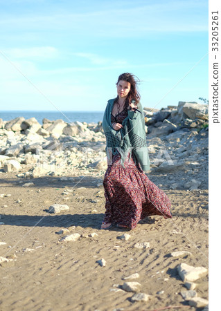 Beautiful young woman on a sea-shore Beautiful young woman on a sea-shore 33205261