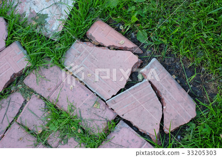 broken road of pink tile overgrown with green broken road of pink tile overgrown with green 33205303