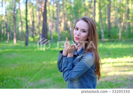 Beautiful Young Woman Blowing A Kiss, outdoor Beautiful Young Woman Blowing A Kiss, outdoor 33205350