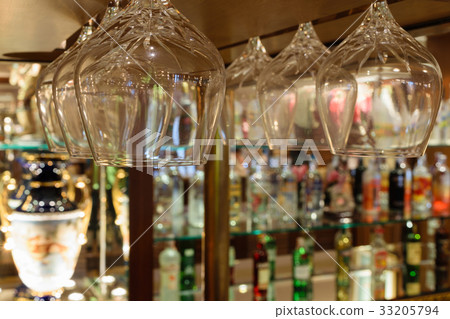 Whiskey glass and Bottles of whiskey at the bar Whiskey glass and Bottles of whiskey at the bar 33205794