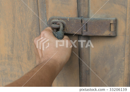 Locked vintage wooden door with hand Locked vintage wooden door with hand 33206139