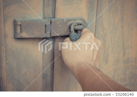 Locked vintage wooden door with hand 33206140