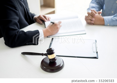 Judge gavel with lawyers advice legal at law firm in background. 33206583