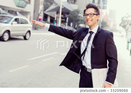 Waving for a taxi in city Waving for a taxi in city 33209088