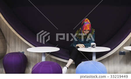 Islam woman sitting using smart phone 33219449