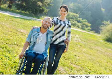 Pleasant young couple posing in the meadow Pleasant young couple posing in the meadow 33220637