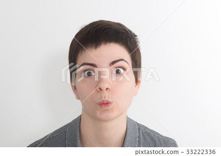 A pretty young woman looks at the viewer with 33222336