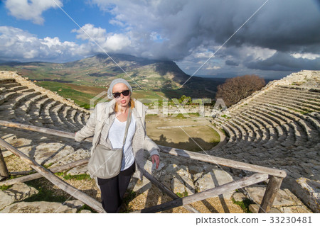 Tourist taking photo in front of greek theater of 33230481